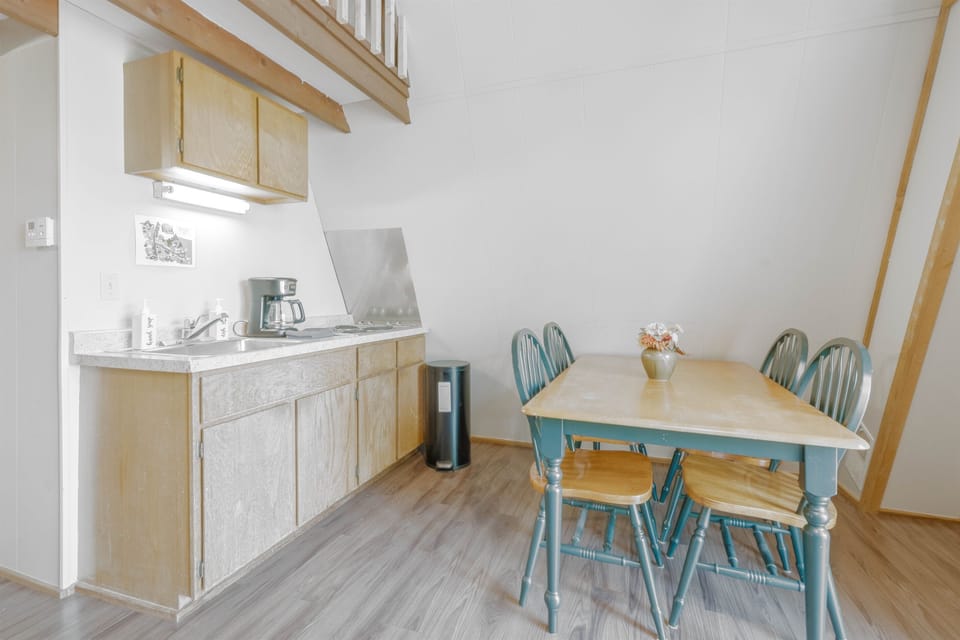 Kitchenette with stove top, microwave, and fridge