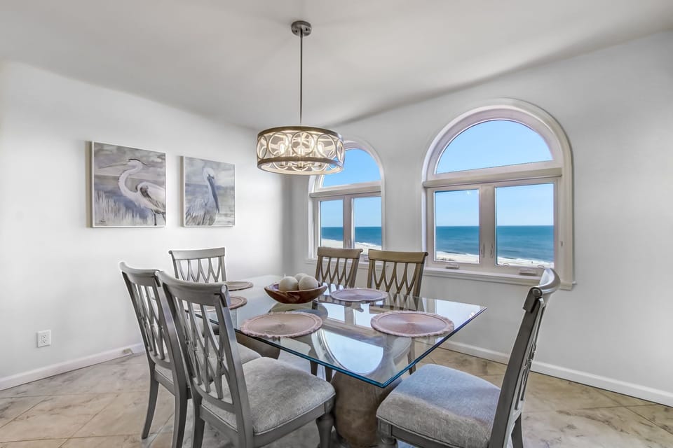 Oceanfront Dining Space with Glass Topped Table Seating Six