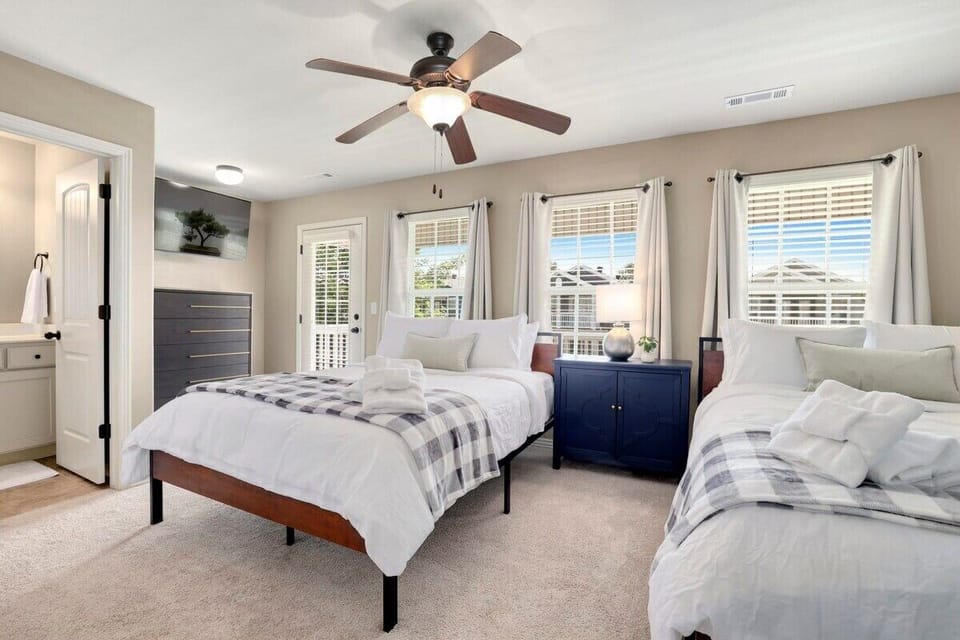 Finally, our fourth bedroom has TWO Queen-size beds, a dresser, a closet, a 50-inch Vizio Smart TV, an en suite bathroom and private access to the upstairs balcony.