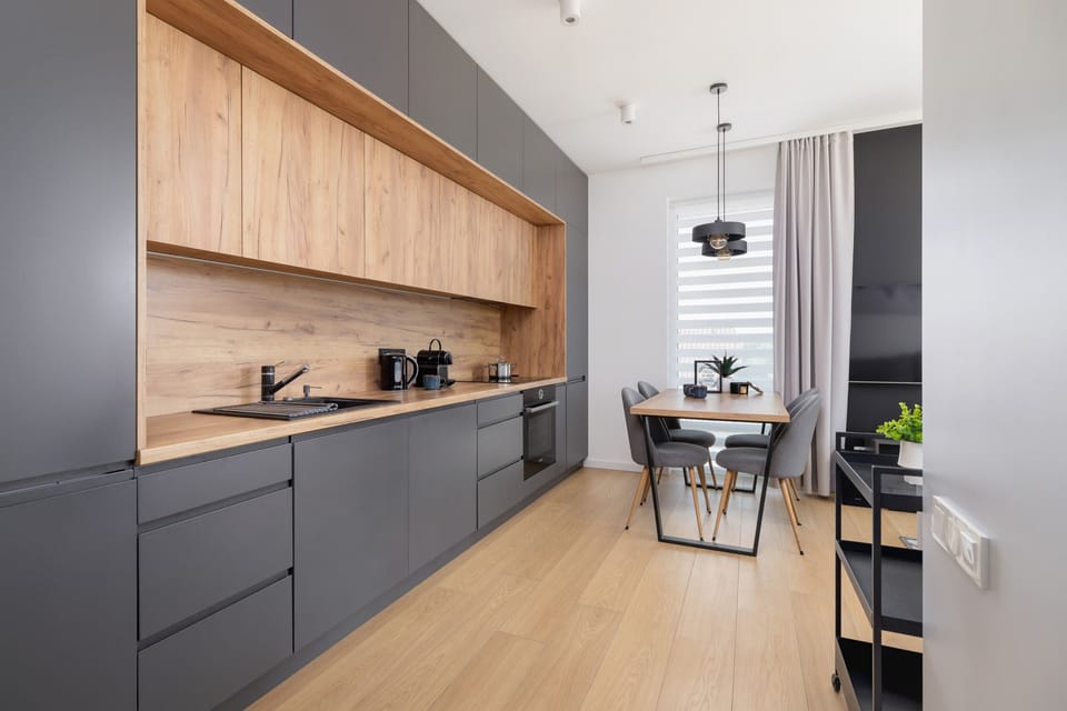 Gray kitchen with cooking utensils. 
