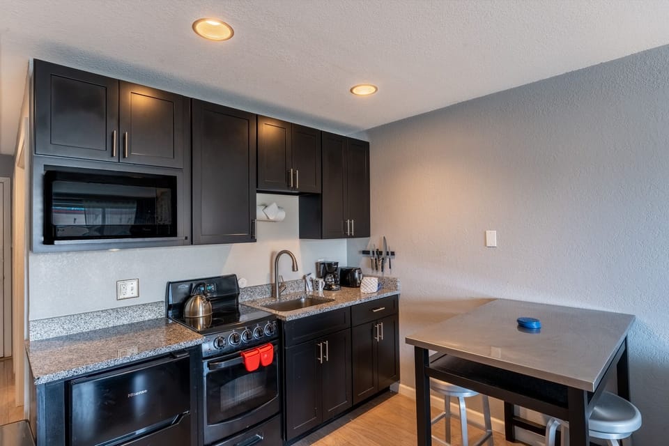 Your sleek kitchen features granite countertops, full-size appliances, and everything needed to prepare meals during your stay.