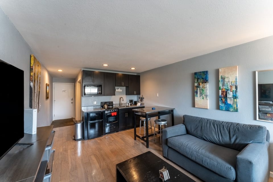 Relax in your modern suite with sleek kitchen, cozy seating, and stylish décor—everything you need for a comfortable stay.