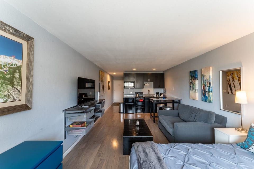 Unwind in your modern open-concept space with stylish furnishings, full kitchen, and contemporary artwork creating the perfect home away from home.