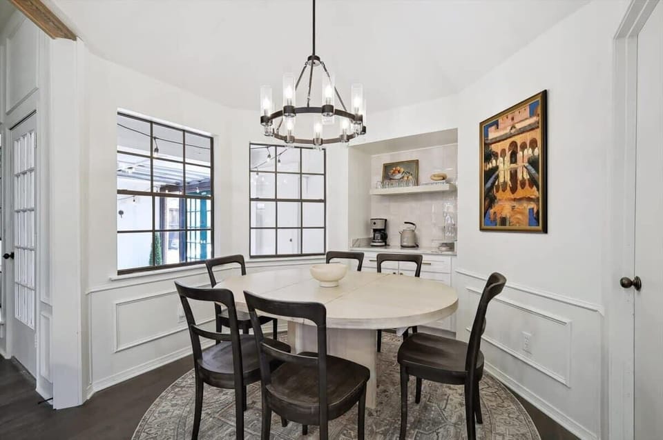 Featuring a nook with a coffee machine, kettle, and utensils, this uniquely circular dining room will instantly transport you to a chic European-style restaurant.