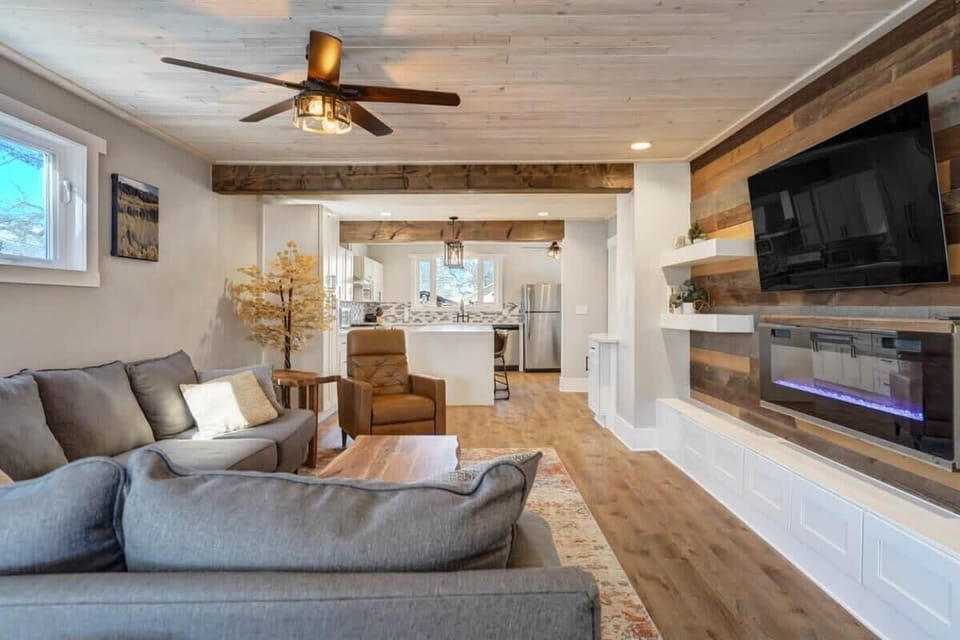 Kick back on the roomy sectional for a movie night, with the TV and glowing fireplace-style feature as the cozy focal point.