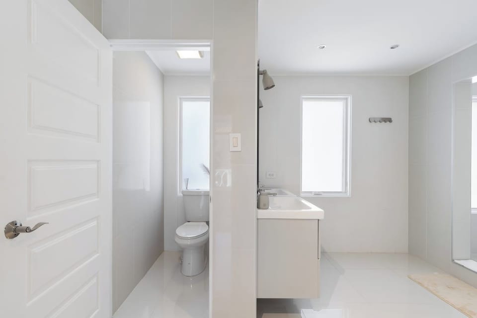 High-class Bathroom of the villa in Noord Aruba - Beautiful Vanity with large size wall mirror - Sufficient storage space - Neat and clean toilet seat - Availability of all bathroom amenities - Stunning shower area