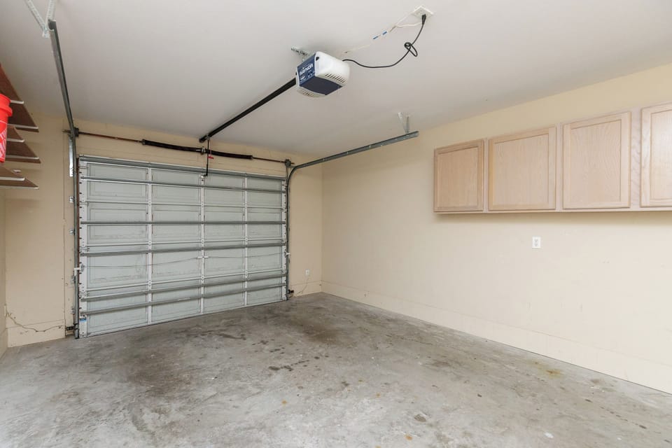 Secure garage with built-in storage cabinets provides convenient parking and extra space for your belongings during your stay.