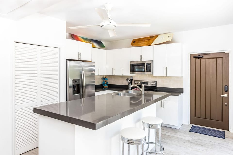 The kitchen is fully stocked with all the necessary utensils and amenities.