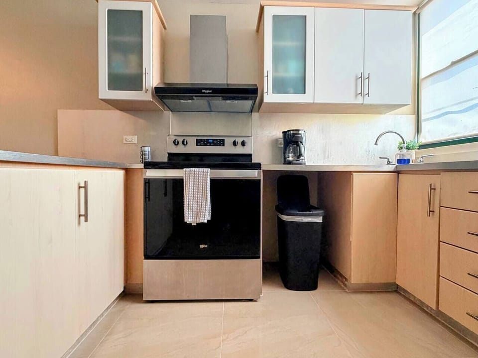 Bright modern kitchen with stainless steel appliances and natural light