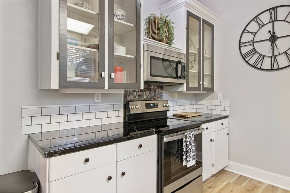 Left side of kitchen with electric stove and microwave