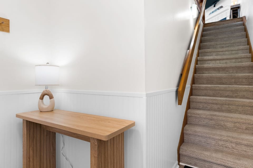 Carpeted stairs from the foyer to the main level