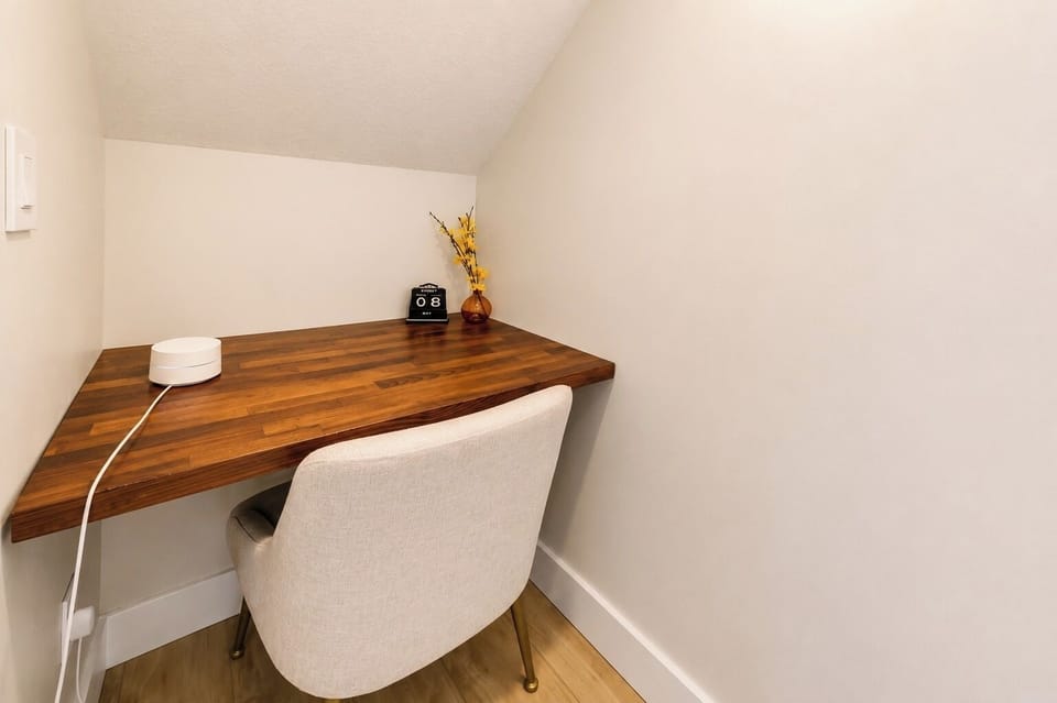 Cozy minimal workspace under a sloped ceiling
