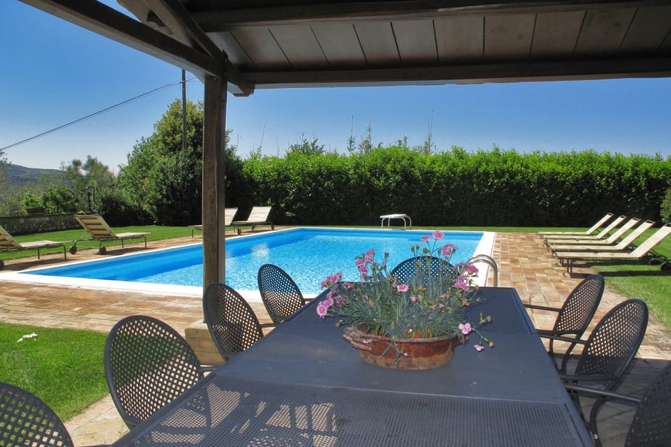 The equipped pergola close to thee pool area