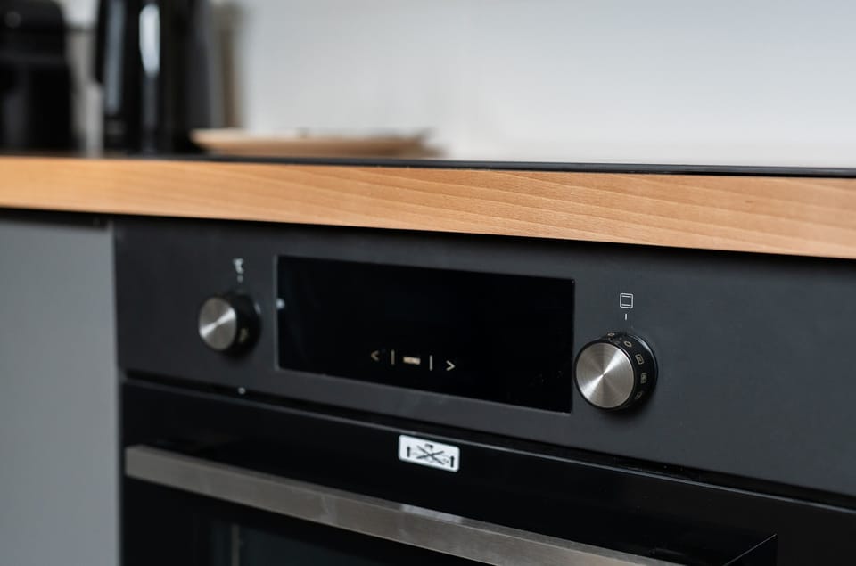 A detailed view of the kitchen’s oven, showcasing its high-quality build and sleek black finish.
