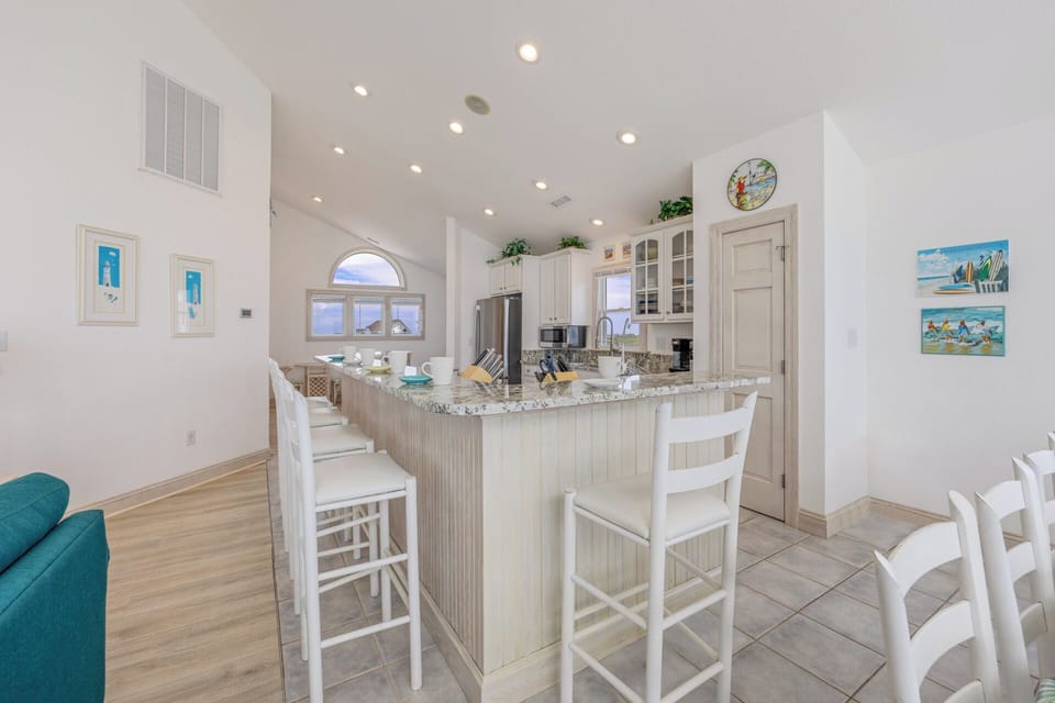 The large kitchen, featuring stainless steel appliances, lots of cookware, plentiful cabinets, and ample counter space makes cooking meals a breeze.