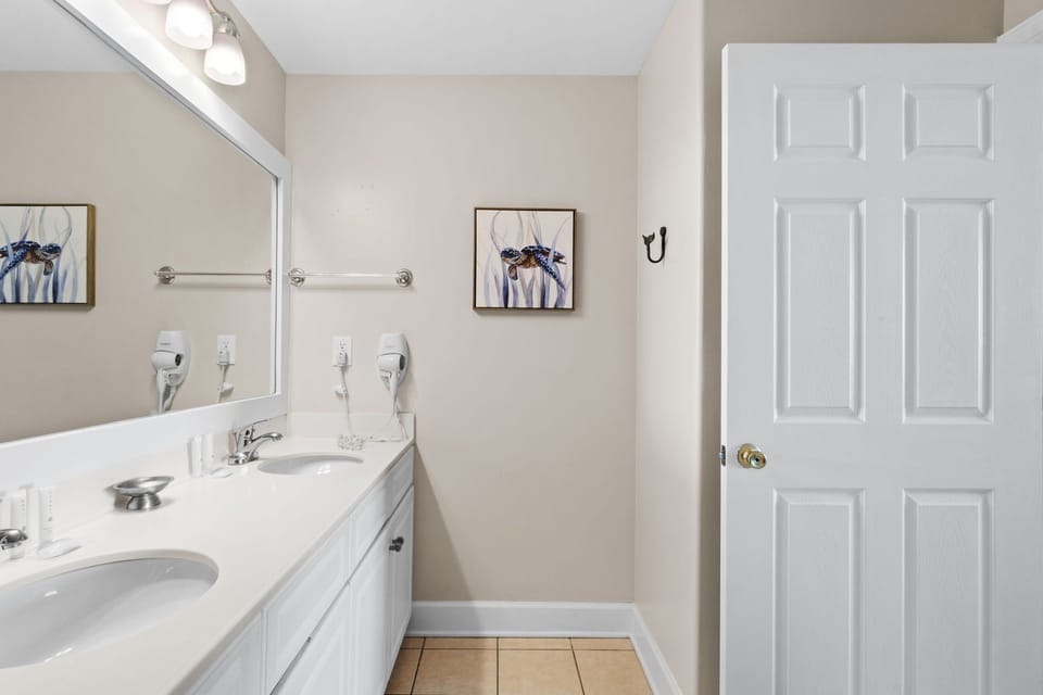 The primary ensuite features a tiled step‑in shower with a clean, modern look.