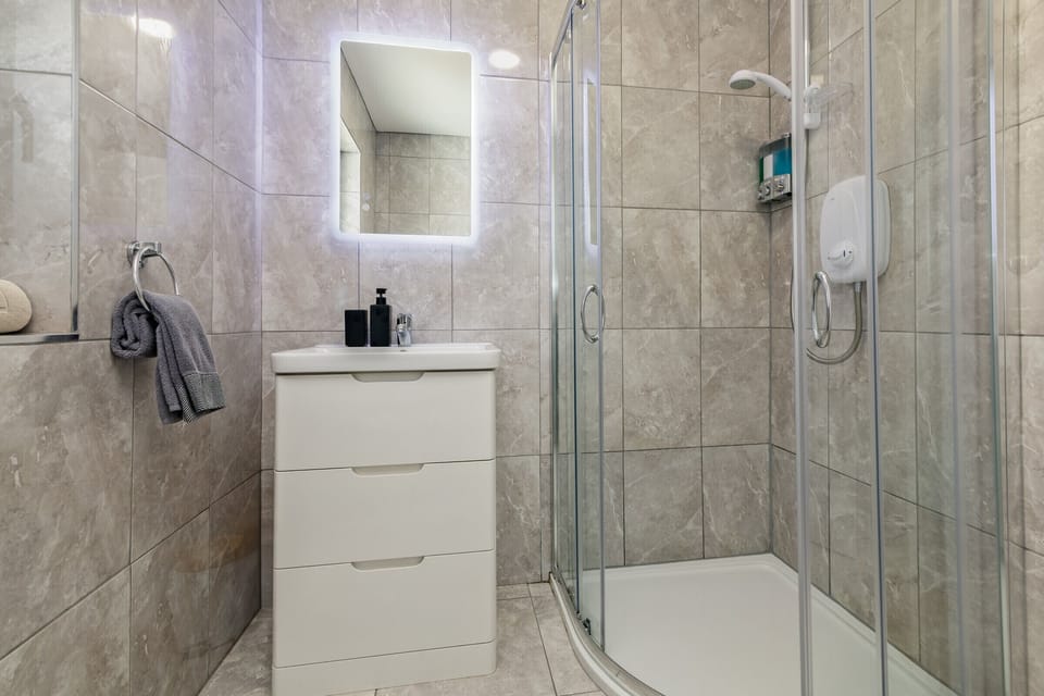 The bathroom has an ever-so-metro look and a walk-in shower.