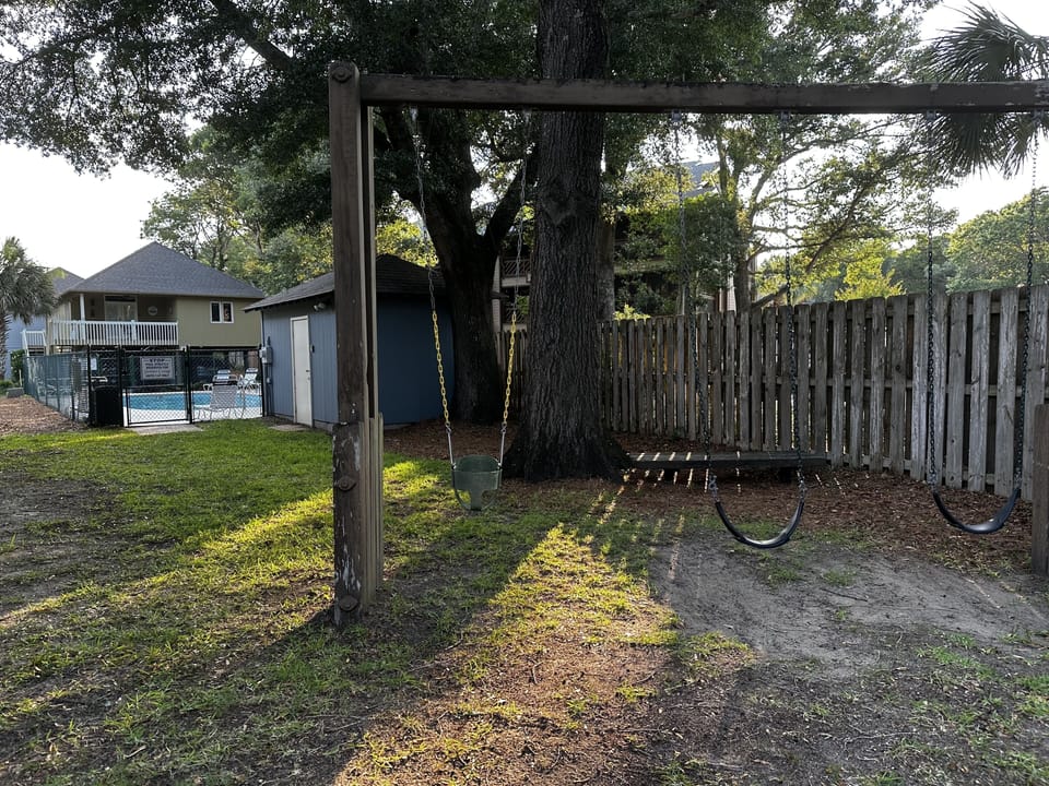 Swing set in front of cottage