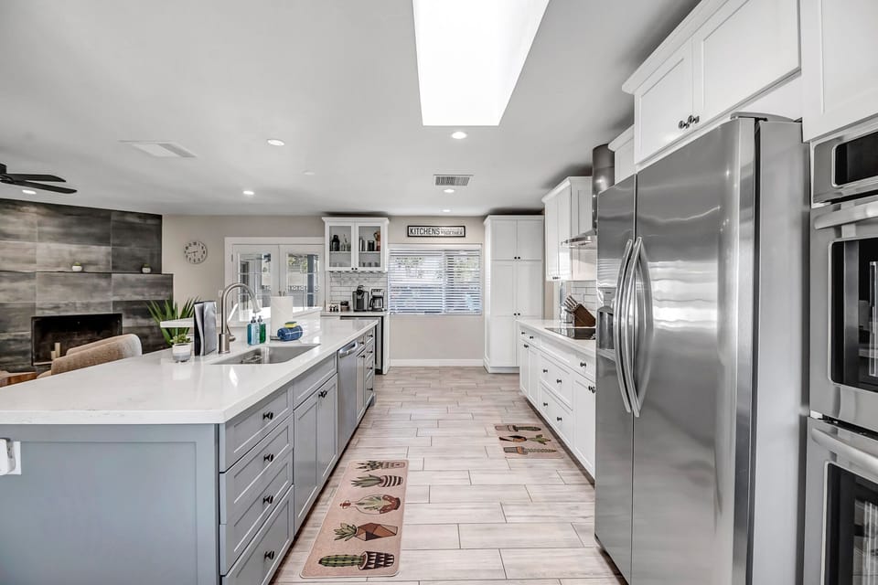 Fully Equipped Kitchen with Stainless Steel Appliances And Bar Seating