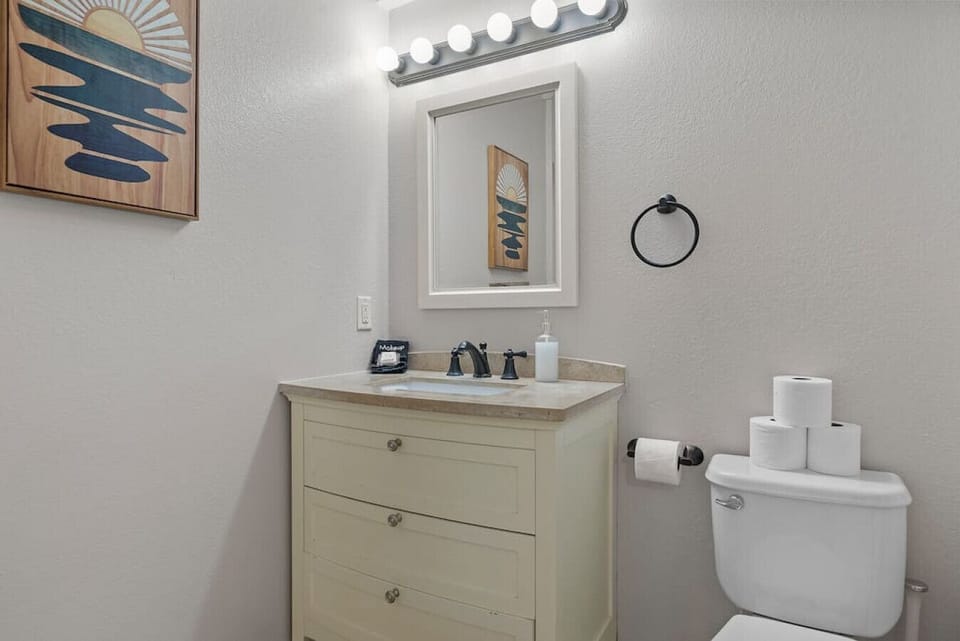 Well-lit mirror that provides ample illumination, allowing you to perfect your grooming routine with ease, and a well-cleaned toilet for your personal necessities