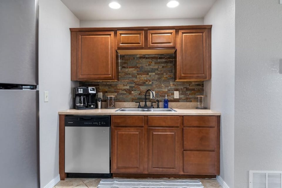 Beautifully designed kitchen with cabinets for ample storage, a convenient coffee maker, and a modern dishwasher, ensuring that your kitchen experience is brimming with convenience.