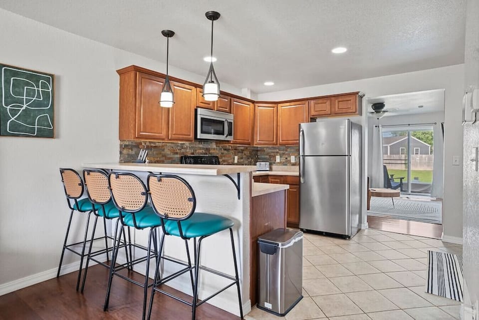 Elegant kitchen with kitchen countertop and chairs which is thoughtfully designed to optimize efficiency and convenience while cooking and preparing food