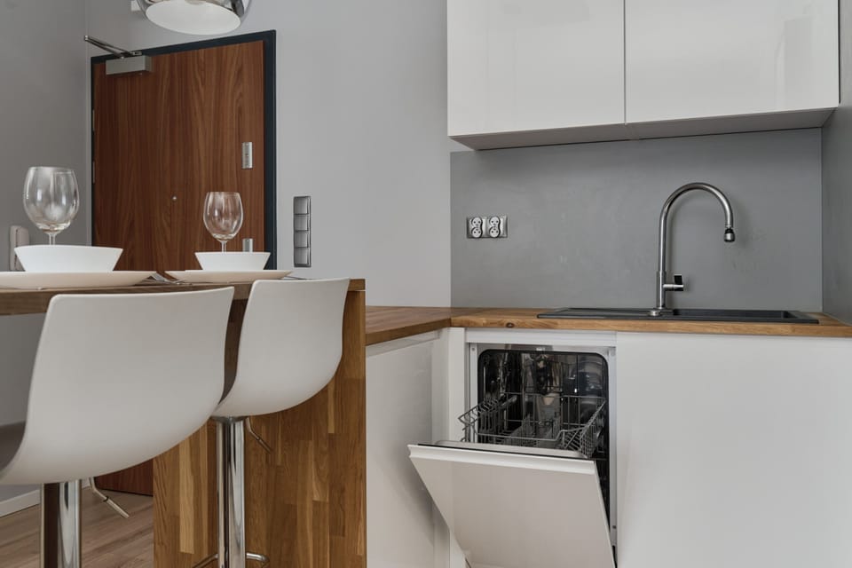 A section of the kitchen with an island, chairs, and visible decorative details.
