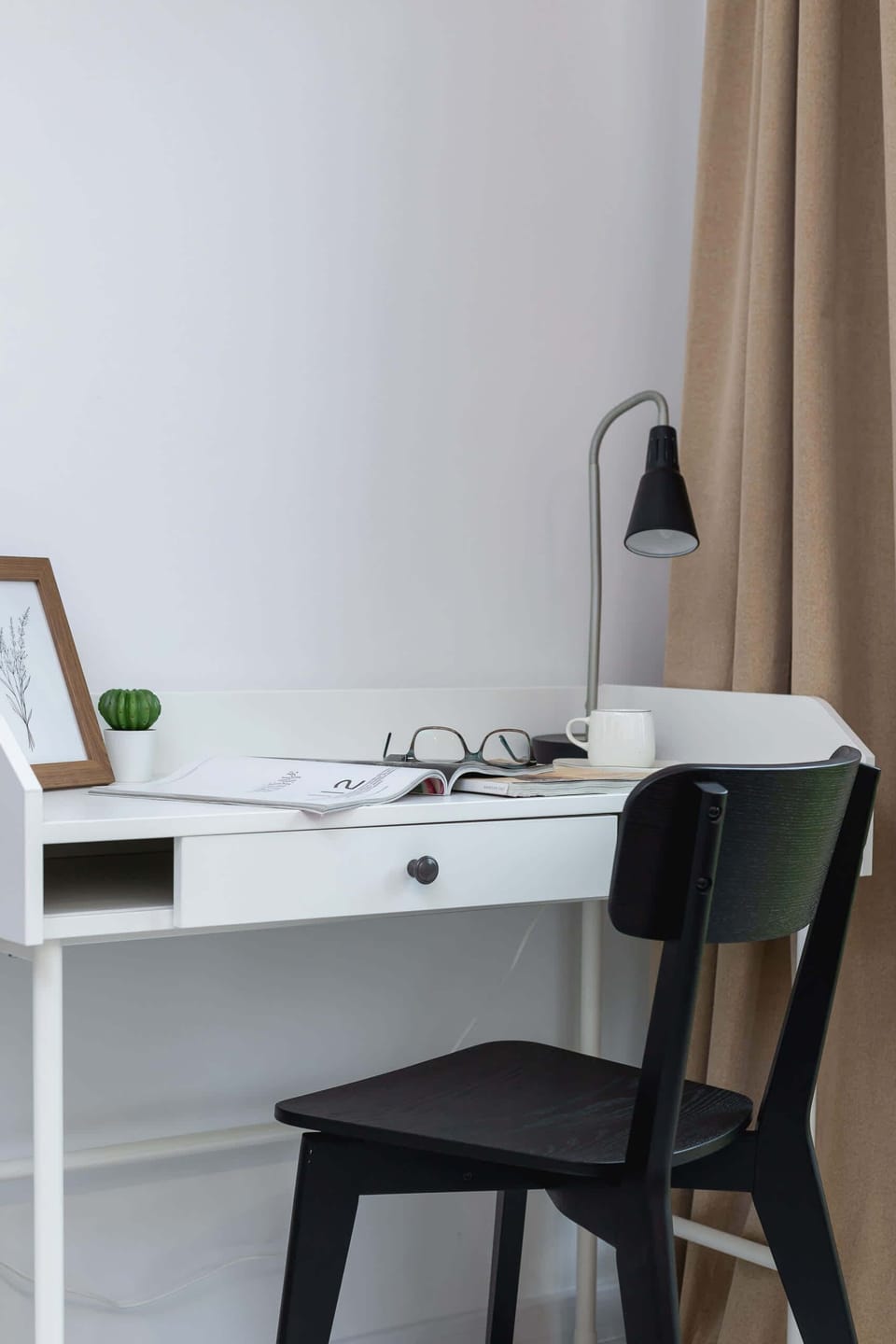 Work desk with a chair and lamp, perfect for productivity and modern design.
