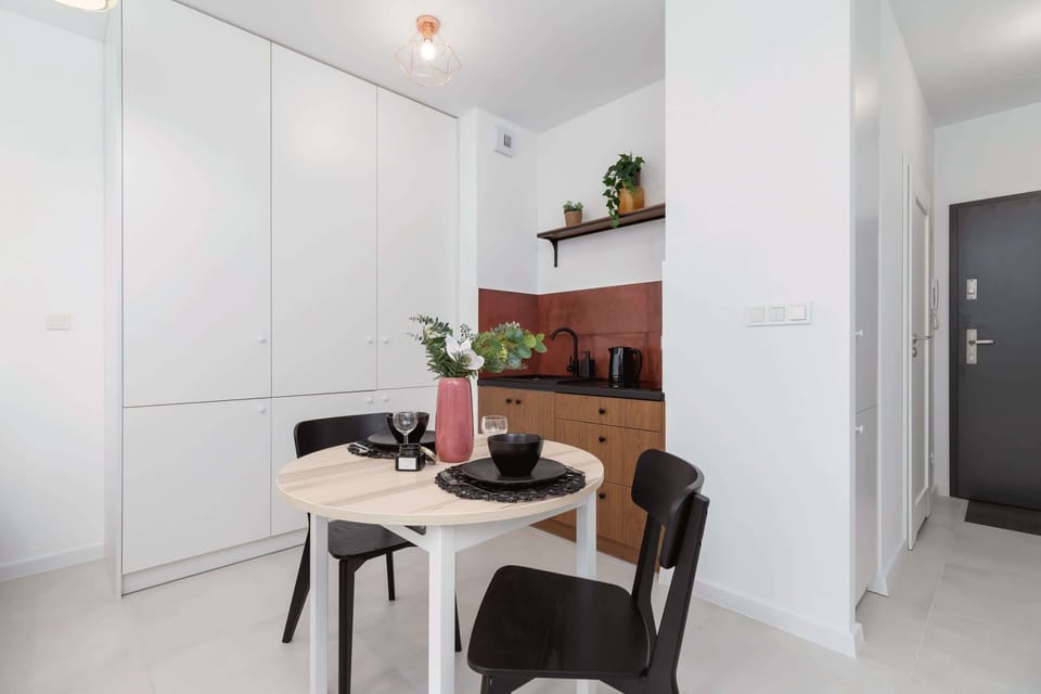 Dining area with a table, chairs, and a modern minimalist design, set in a cozy atmosphere.
