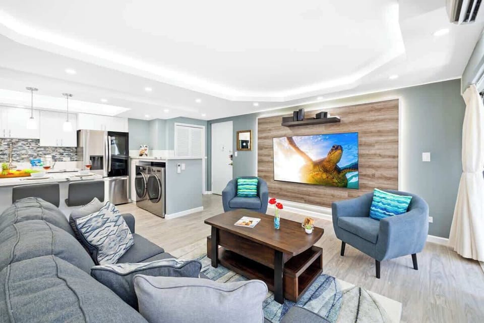 The living room has a flat screen TV, queen-size sleeper sofa, coffee table, and 2 chairs perfect for relaxation!