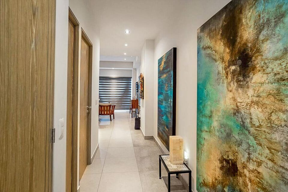 Hall with access to the washer and dryer and bathroom