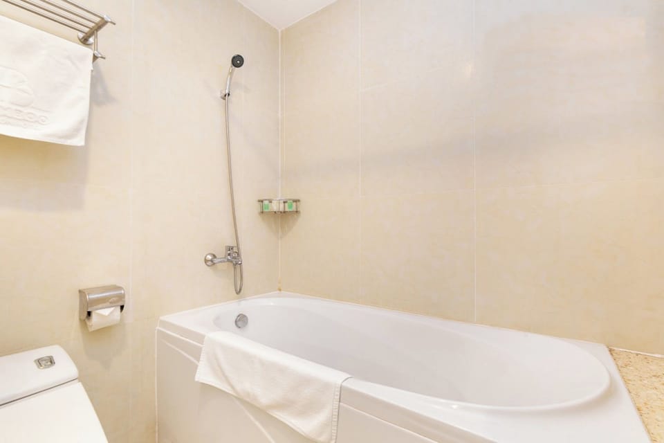 Separate tub and shower, hair dryer, slippers, towels