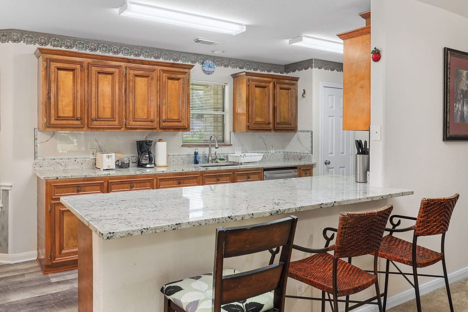 Kitchen has a large island that sits three