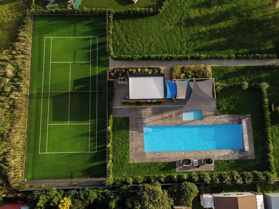 Bird's eye view of Communal Heated Swimming Pool + Tennis Court