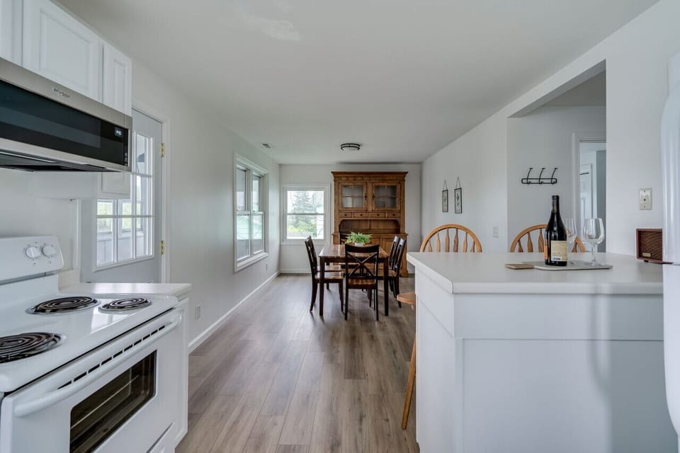 Full kitchen with bar seating and connected dining
