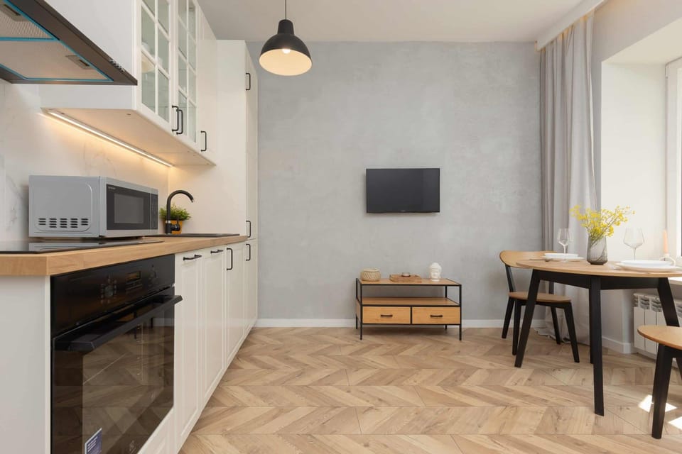 Another angle of the kitchen and dining area, highlighting the modern appliances and open-plan layout.
