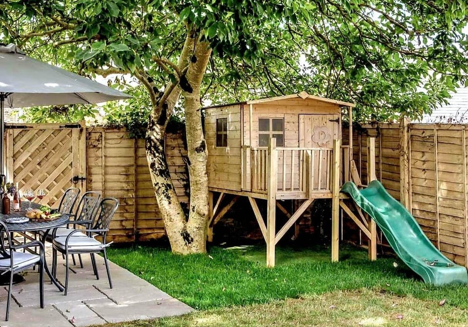 Wooden playhouse and slide, outdoor and beach games and toys for children 