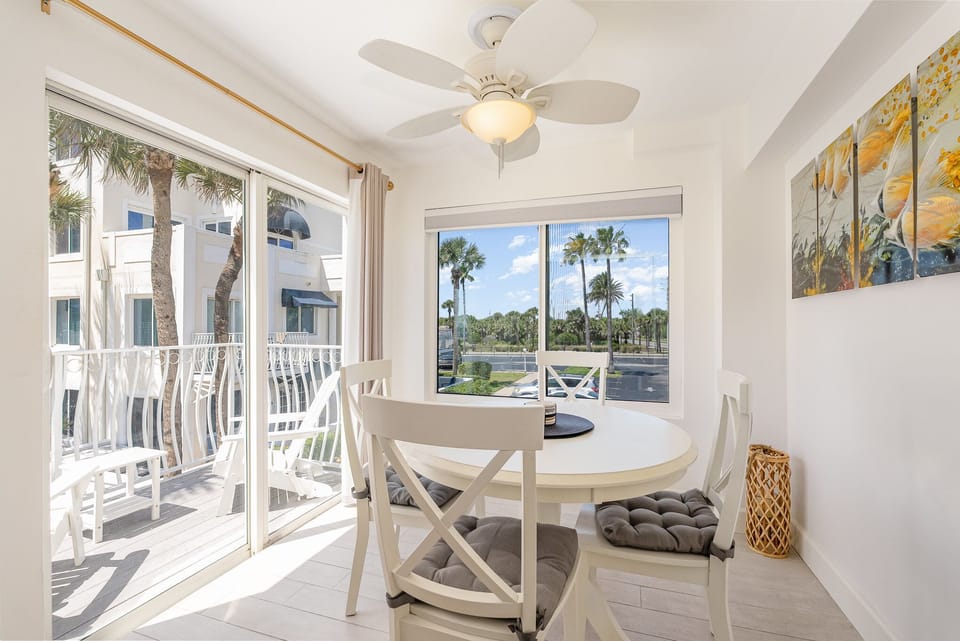 Bright and airy dining area facing balcony 