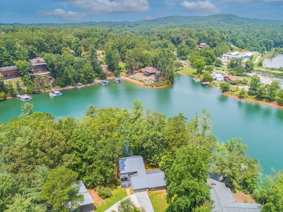 "Stunning lake views with clear water and peaceful tree surroundings."