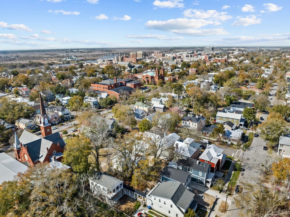 Aerial shot of The Yak Shack and downtown Wilmington with U.S.S North Carolina