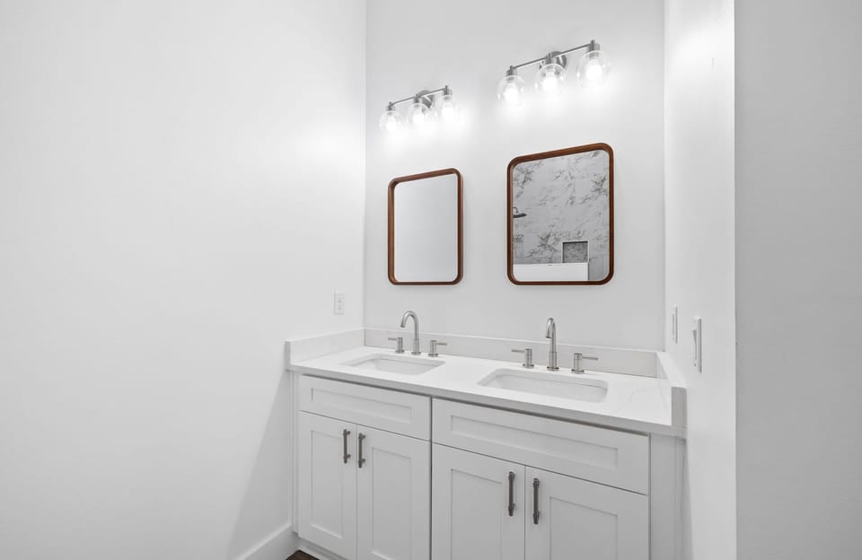 Clean bathroom vanity w/ mirror & bright lighting