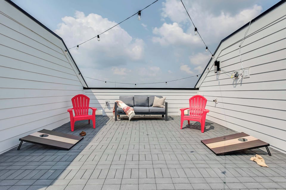 *The rooftop hosts two sofas, colorful adirondack chairs, a loveseat, string lights, a light up Nashville sign, and corn hole/bags game!