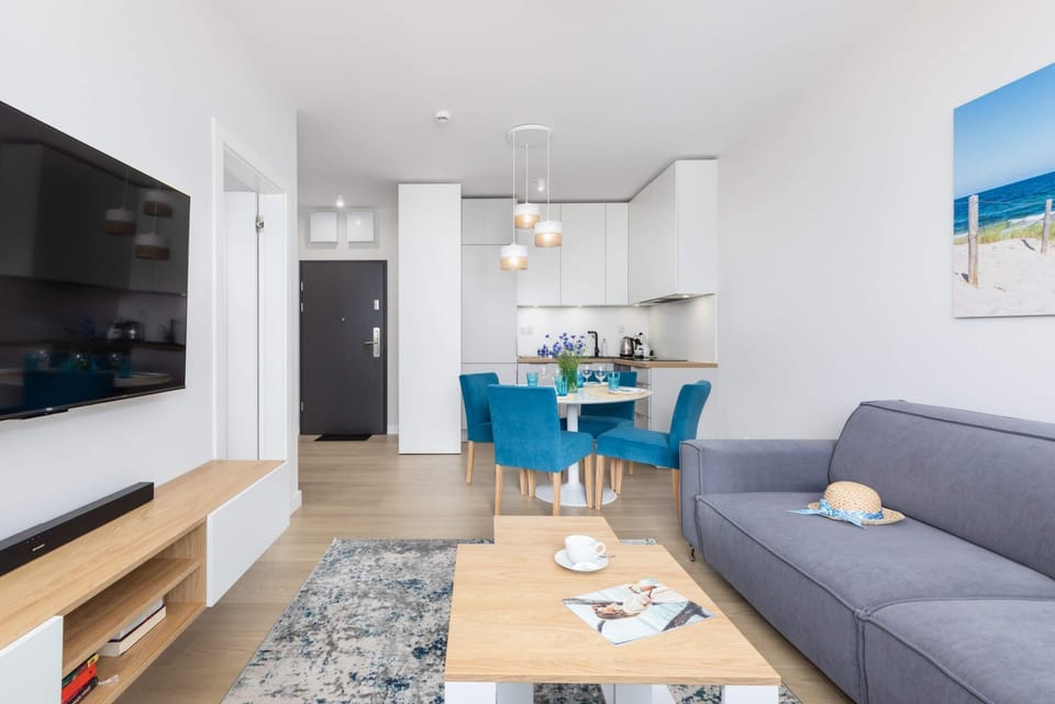A full shot of the open-concept living space leading into the kitchen, emphasizing modern design.
