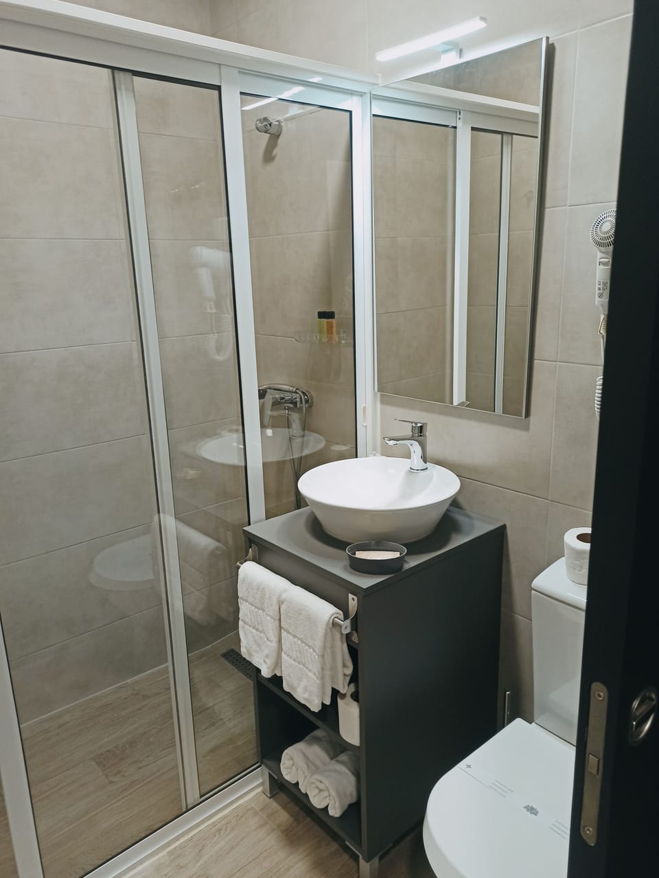 Shower, rainfall showerhead, hair dryer, towels