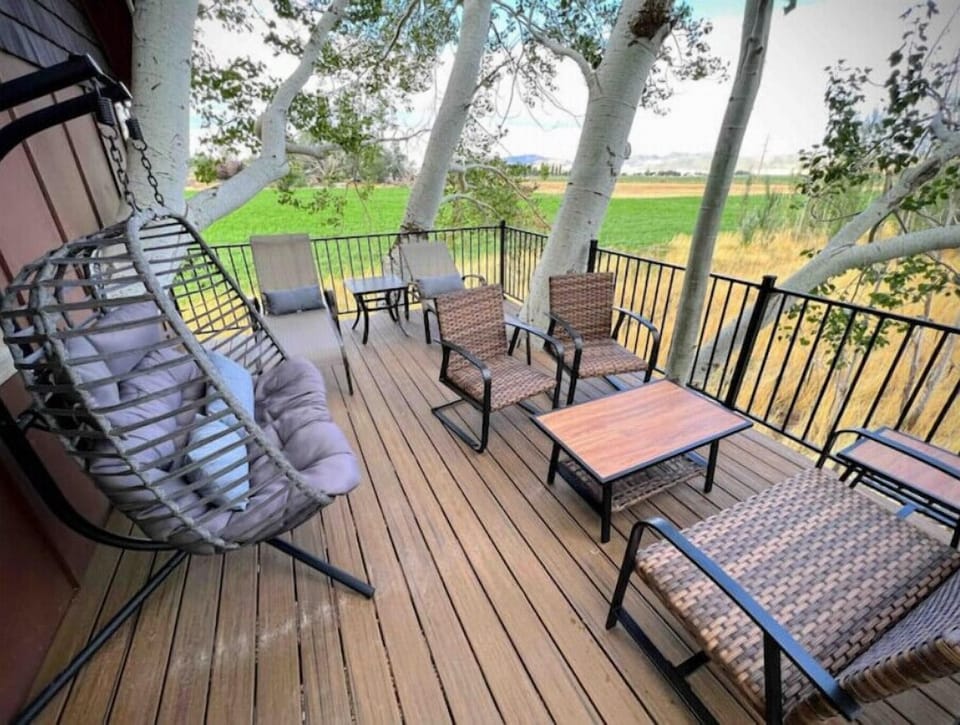 A large deck attached to the treehouse. The hanging love seat is a favorite!