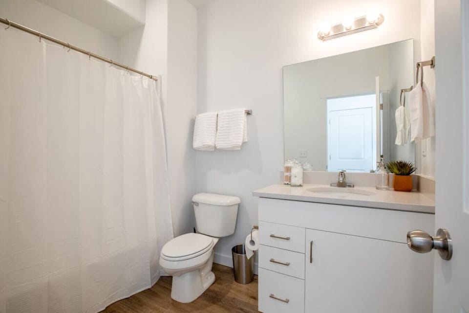 Full bathroom with shower/tub combo and modern vanity