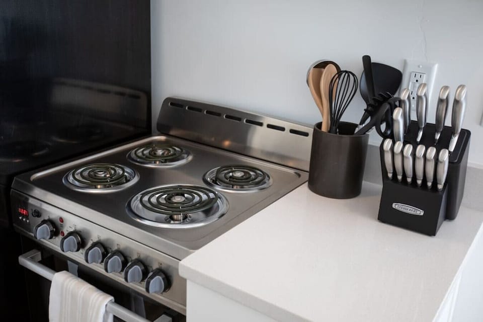 Kitchenette with electric stovetop and cooking essentials