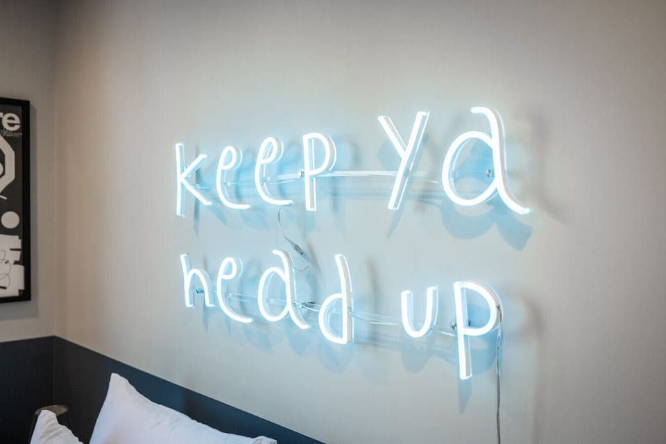 Fun neon wall décor gives the Chill Pad its signature vibe
