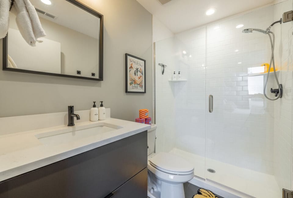 Modern bathroom with glass shower and sleek vanity
