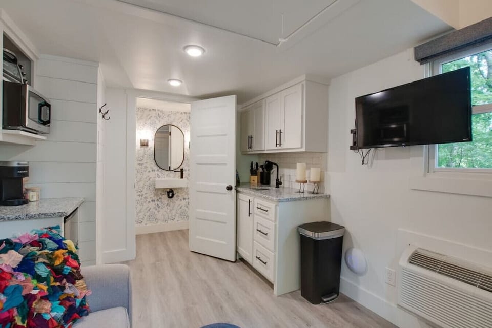 Step into the chic bathroom inside our tiny cottage. Thoughtfully designed with modern touches, sleek fixtures, and amenities for a relaxing experience surrounded by nature